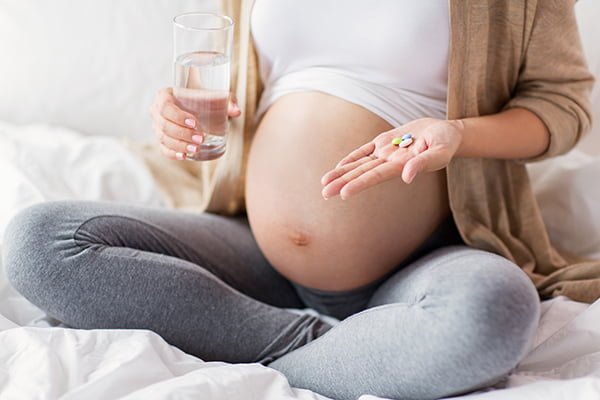 Gravid kvinna med värktabletter