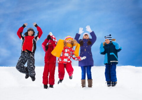 Kids jumping in snow